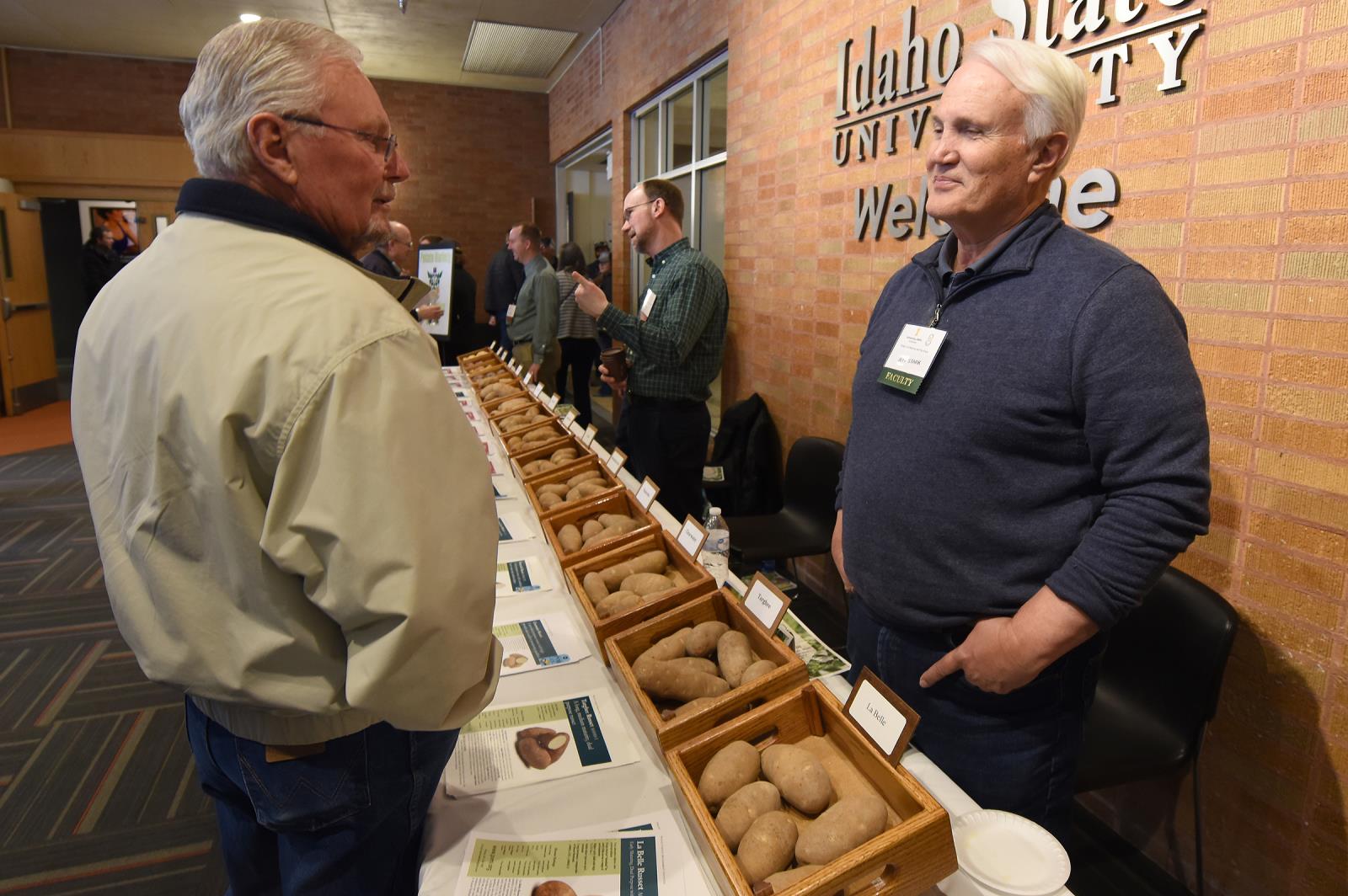 Jeff Stark, right, speaks with Randy Thomas of Blackfoot during the 2020 Idaho Potato Conference in Pocatello in January. Stark, who retired in January, oversaw the release of more than 20 new potato varieties during his time as director of the University of Idaho’s Potato Variety Development Program.