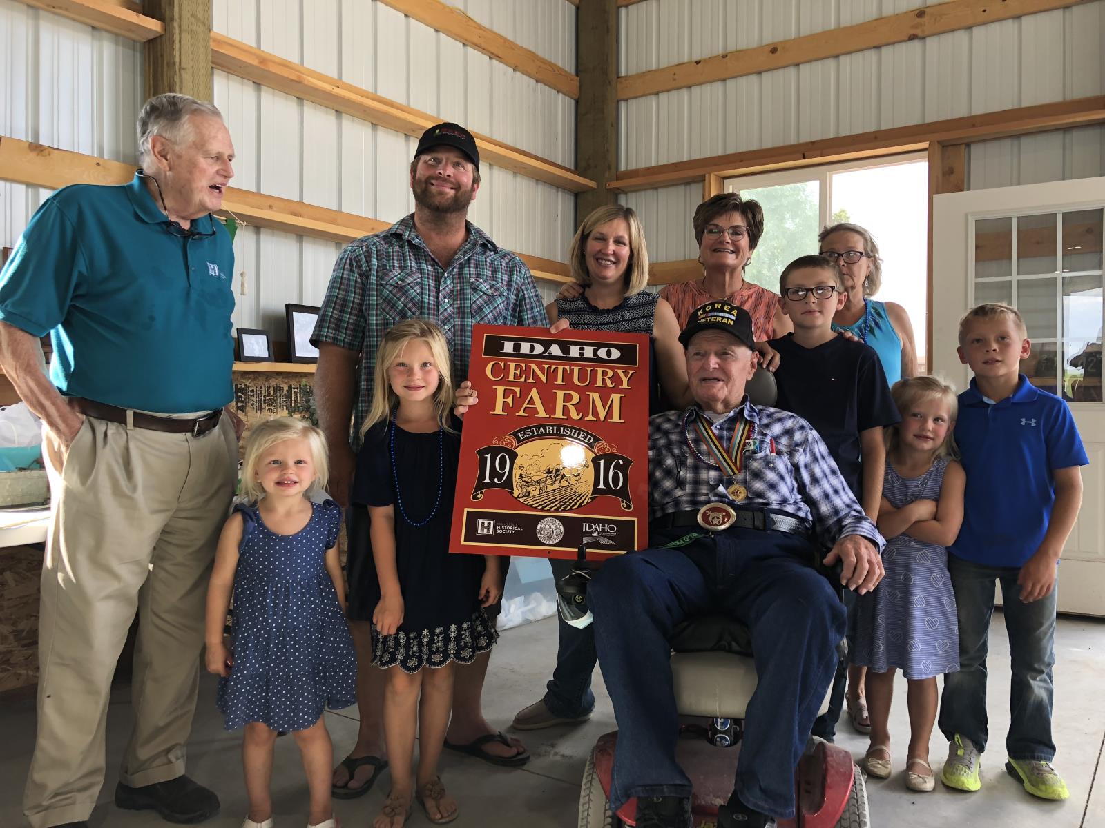 Members of the Reed family are presented a plaque recognizing their farm in Filer as a Century Farm. 