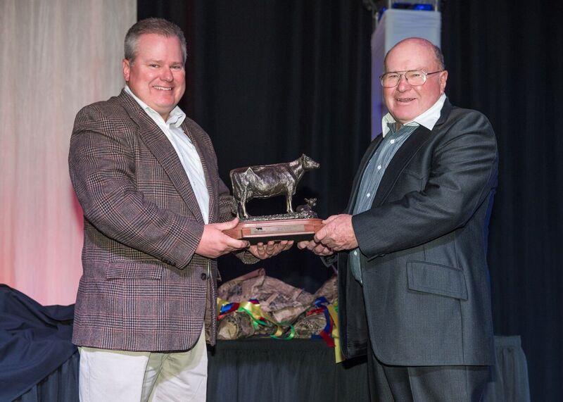 Brent Jackson, right, is presented an award signifying his induction into the Idaho Dairy Hall of Fame.