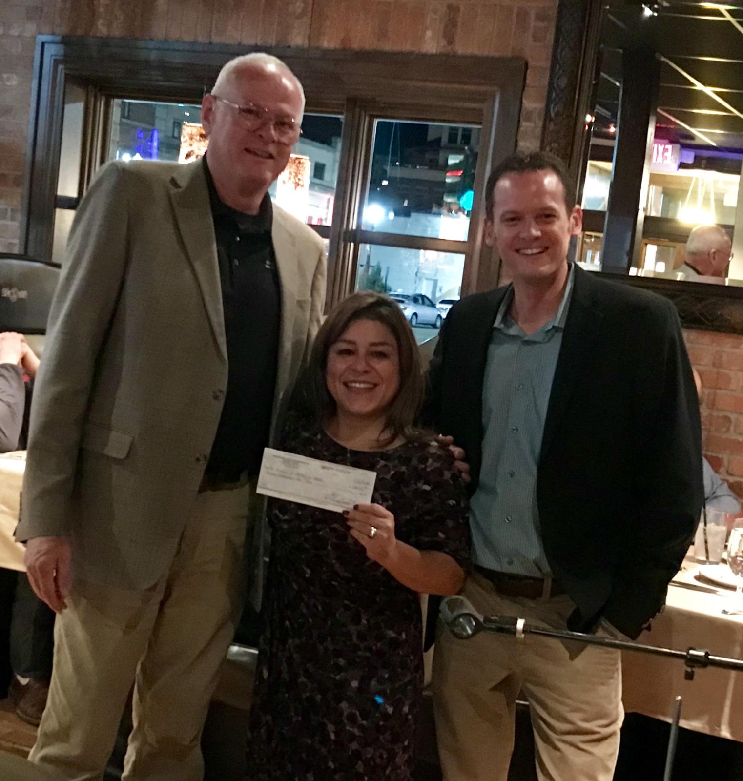 Community Council of Idaho Executive Director Irma Morin receives a check for $60,000 from Idaho Dairymen’s Association CEO Rick Naerebout, right, and IDA Governmental Affairs Director Bob Naerebout. The money will be used to support CCI’s newly formed immigration legal services program, Familias Unidas.