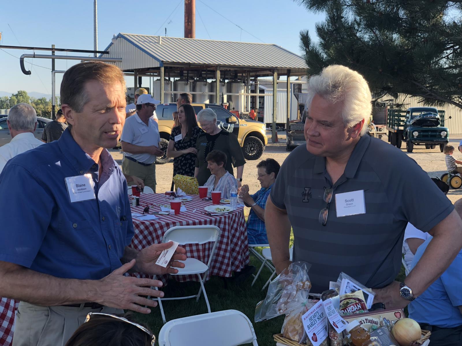 New University of Idaho President C. Scott Green, right, speaks with Blaine Jacobson, executive director of the Idaho Wheat Commission, July 24 during Food Producers of Idaho’s annual summer barbecue. 