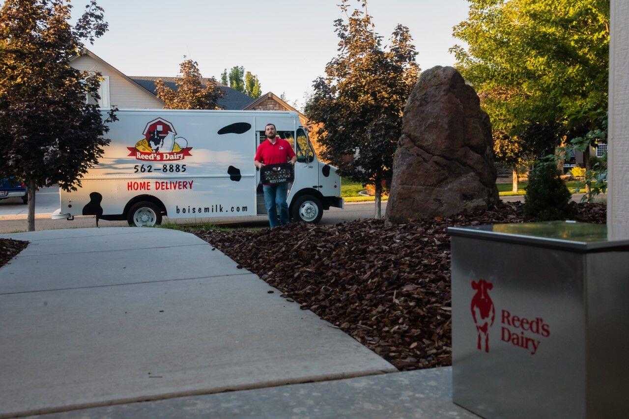 A Reed’s Dairy employee delivers food items to a home in the Treasure Valley of southwestern Idaho. Reed’s home-delivery service in the Boise area is booming during the coronavirus outbreak but the Idaho Falls operation’s dairy retail stores are suffering.