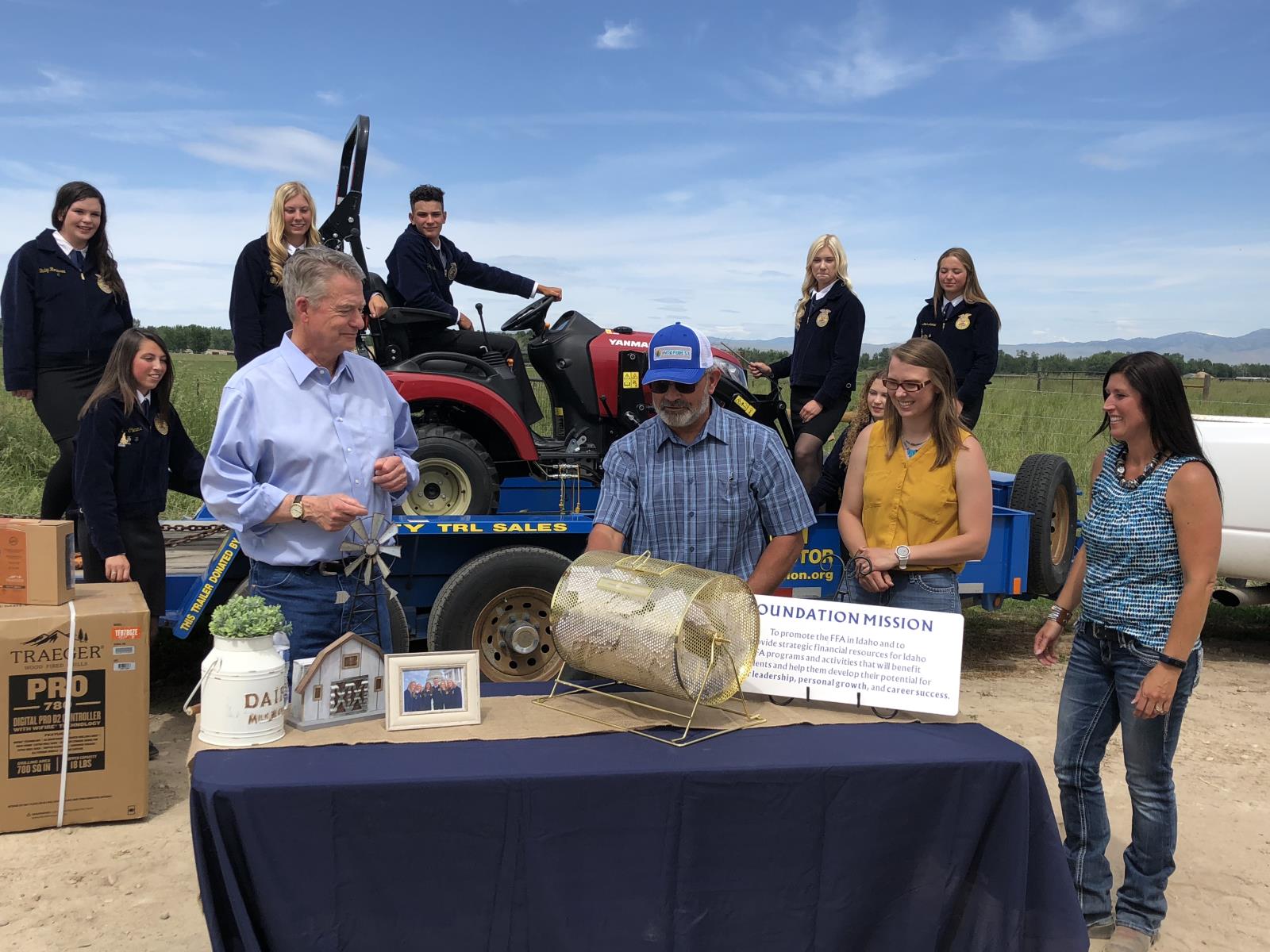 Gov. Brad Little, left, prepares to draw the winning ticket for the FFA’s tractor raffle, June 3 in Caldwell. Despite challenges posed by the coronavirus outbreak, the raffle program generated more revenue from ticket sales this year. 