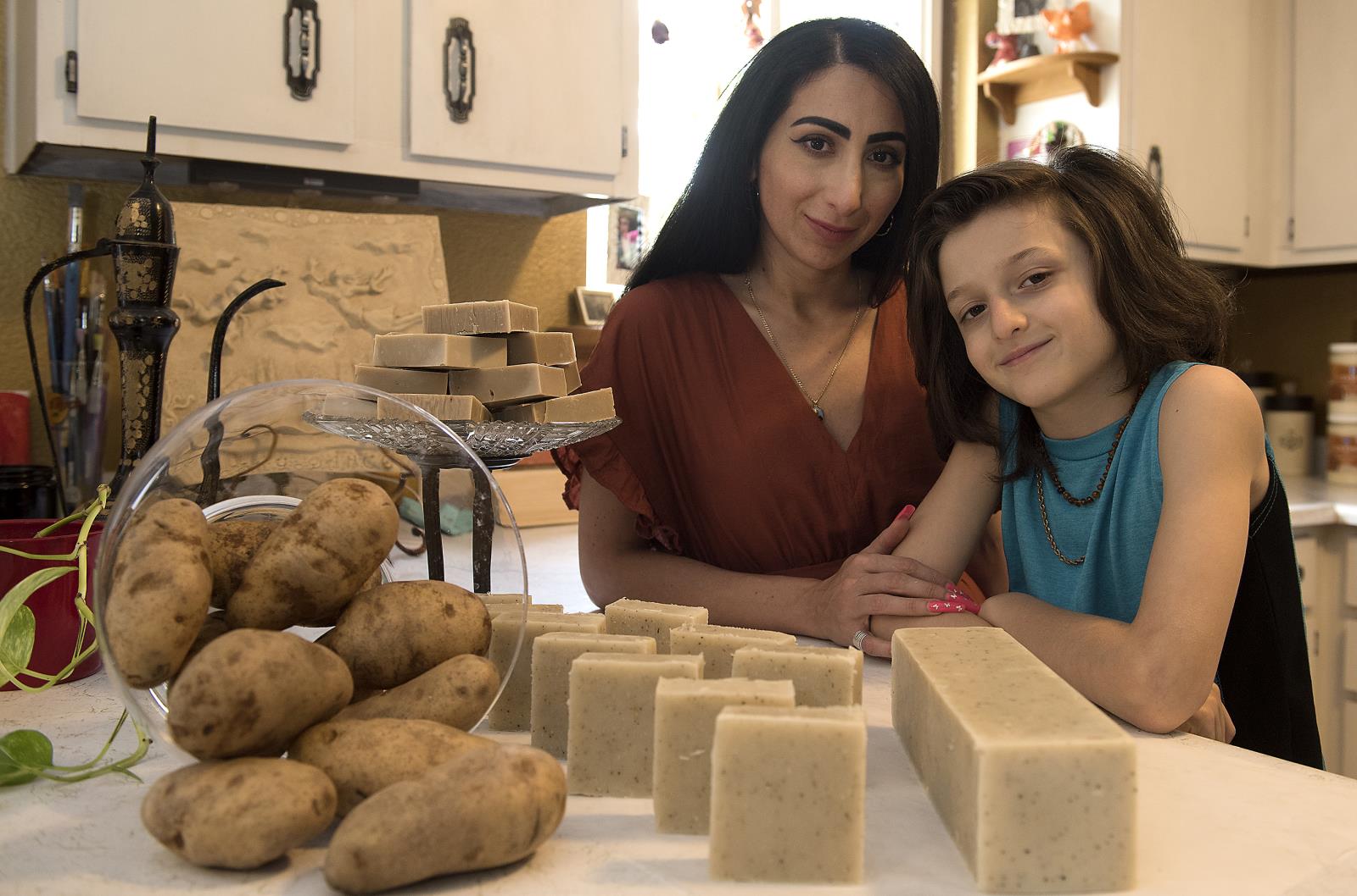Liyah Babayan and her son, Dominic, 10, with a collection of Make Peace soap bars.