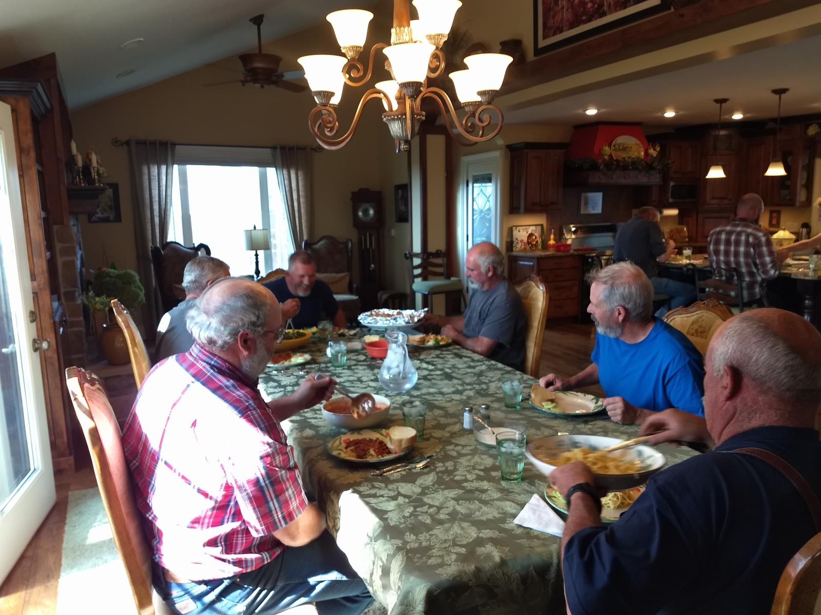 Workers helping with the Thiel family's potato harvest in Idaho Falls sit down to dine on a large meal prepared by Joyce Thiel. 