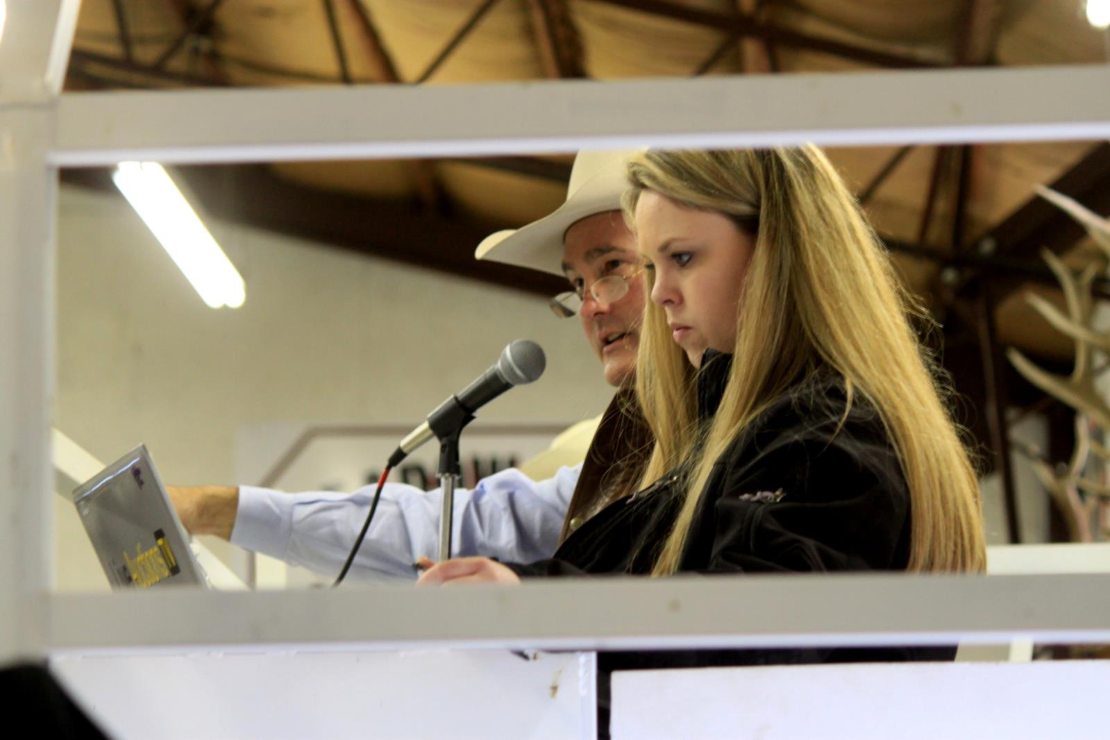 Katie Colyer, shown here, travels the country with cattle auction sale support and her photography/videography business.