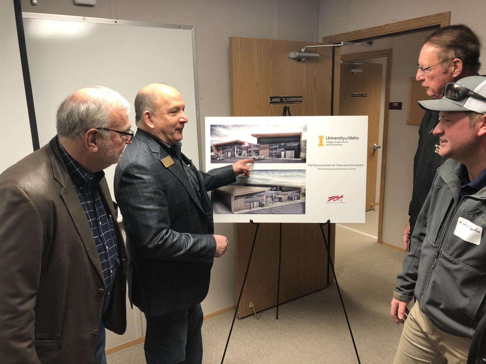 Michael Parrella, dean of University of Idaho’s College of Agricultural and Life Sciences, second from left, speaks with farm industry leaders in February 2019 about a $7 million plan to modernize the university’s Parma ag research center. 