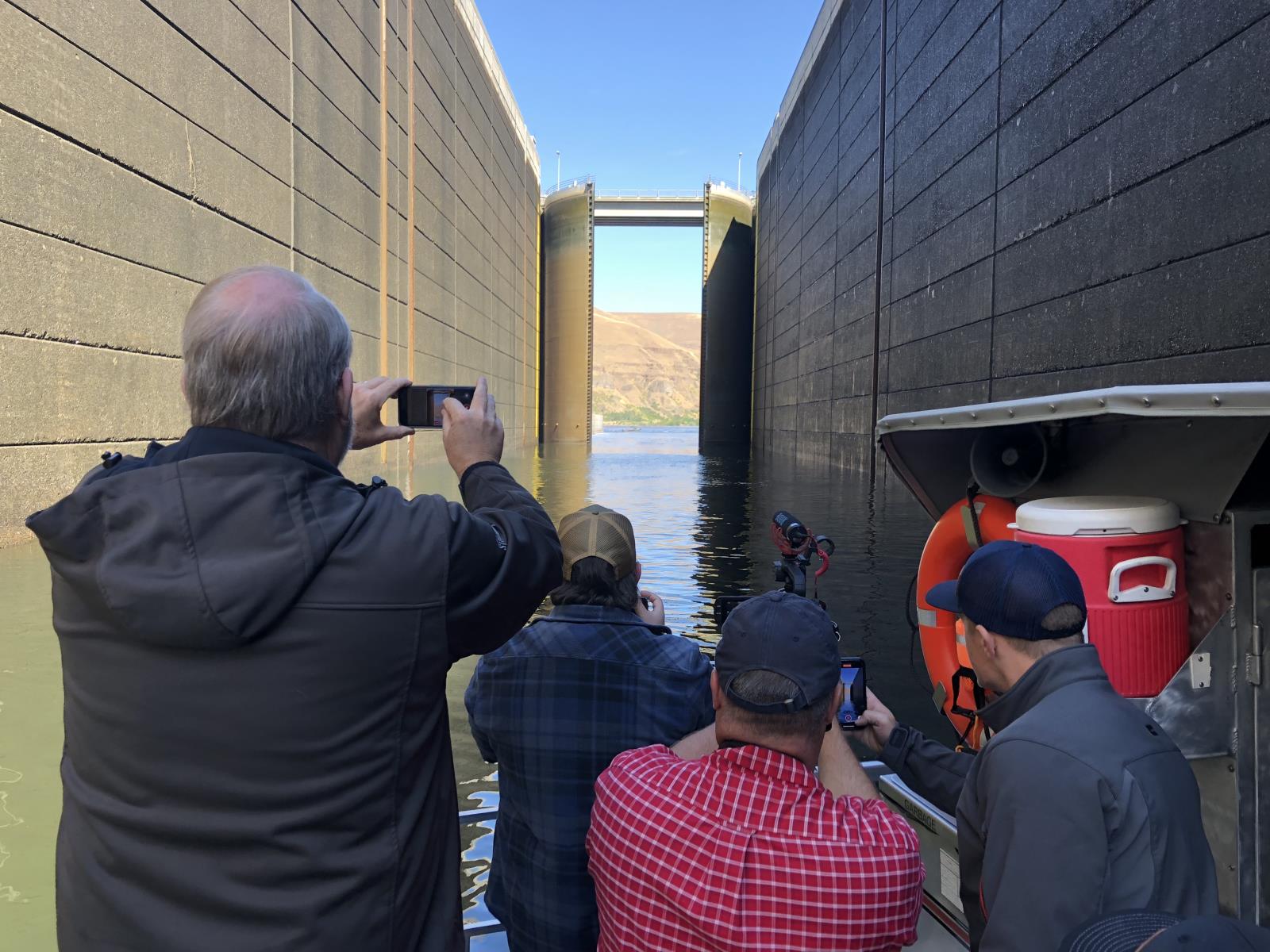 Participants of a June 15-16 dam tour event take pictures of a lock opening at the Lower Granite Dam, one of four lower Snake River dams that have been targeted for removal by some groups over the years. American Farm Bureau Federation President Zippy Duvall and other state, local and national ag industry leaders attended the event. 